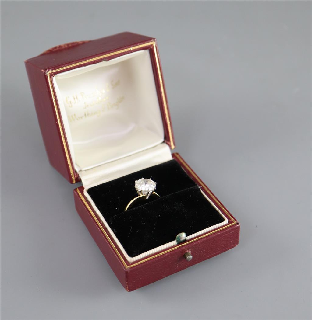 A modern 18ct gold and solitaire brilliant cut diamond ring,